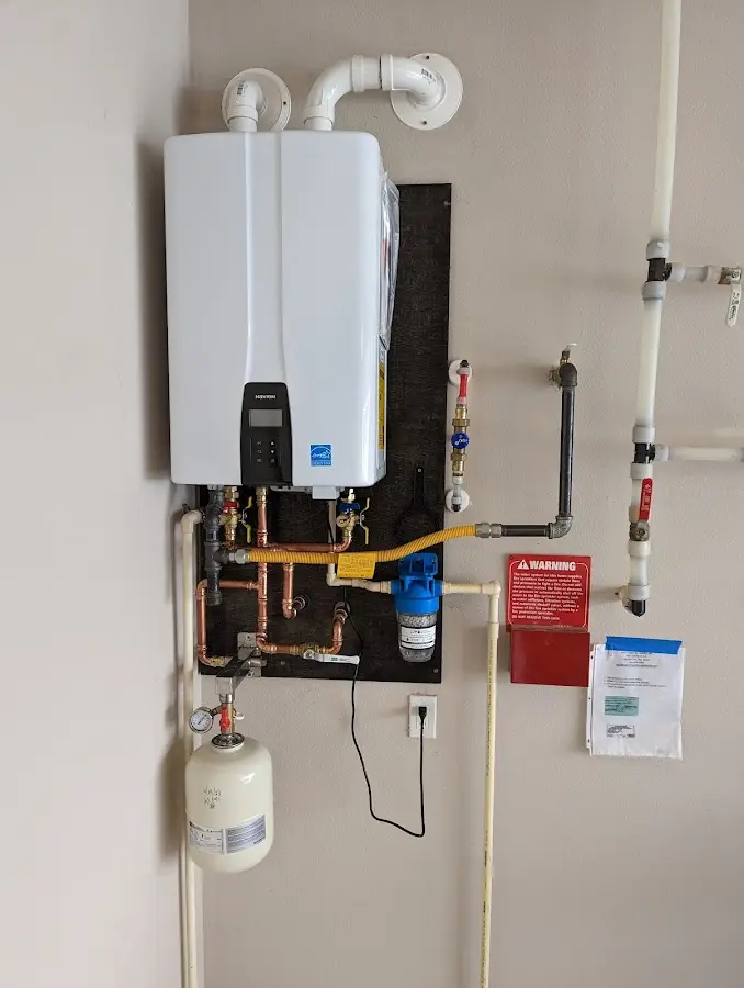 Professional plumber installing copper piping in a Forest Park home